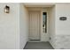 Close up front door and porch; showcasing the house number and an exterior light fixture at 13634 S 192Nd Ave, Buckeye, AZ 85326