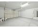 Spacious garage with a large door, concrete flooring, and white walls at 13634 S 192Nd Ave, Buckeye, AZ 85326