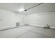 Spacious garage with a door to the house, concrete flooring, and white walls at 13634 S 192Nd Ave, Buckeye, AZ 85326