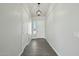 Bright hallway features tile floors and a modern light fixture, leading to various rooms at 13634 S 192Nd Ave, Buckeye, AZ 85326