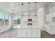 Bright kitchen features a large island, stainless appliances, modern lighting, and a beautiful view at 13634 S 192Nd Ave, Buckeye, AZ 85326