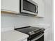 Modern kitchen features stainless steel appliances, white cabinets, and sleek countertops at 13634 S 192Nd Ave, Buckeye, AZ 85326