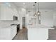 Well-lit kitchen features sleek appliances, a spacious pantry, and a large center island for food prep at 13634 S 192Nd Ave, Buckeye, AZ 85326
