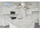 A modern kitchen features stainless appliances, quartz countertops, an island, and plenty of storage space at 13634 S 192Nd Ave, Buckeye, AZ 85326