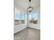 Bright living room featuring wood-look floors, modern light fixture, and serene desert views at 13634 S 192Nd Ave, Buckeye, AZ 85326