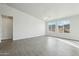 Spacious living room with three large windows and tile floors, creating a light and airy atmosphere at 13634 S 192Nd Ave, Buckeye, AZ 85326