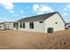 A low angle rear view of a house with large sliding glass doors leading to the back yard at 13634 S 192Nd Ave, Buckeye, AZ 85326