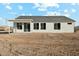 A rear view of a single story house with large sliding glass doors leading to the yard at 13634 S 192Nd Ave, Buckeye, AZ 85326