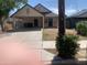 View of the home's facade, featuring a covered carport, neutral paint and limited landscaping at 141 N Pasadena --, Mesa, AZ 85201