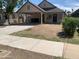 View of the home's facade, featuring a covered carport, neutral paint and limited landscaping at 141 N Pasadena --, Mesa, AZ 85201