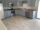 Modern kitchen with stainless steel appliances, gray cabinets and laminate countertops at 141 N Pasadena --, Mesa, AZ 85201