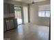 View of modern kitchen extending to dining area, showing stainless steel appliances and access to patio at 141 N Pasadena --, Mesa, AZ 85201