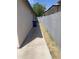 The side yard with concrete walkway and fencing offers privacy and practicality at 141 N Pasadena --, Mesa, AZ 85201