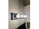 Bathroom vanity lighting, with five white bulbs against a textured wall, brightening up the space at 14543 W Bison Path, Surprise, AZ 85374