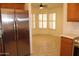 Breakfast nook with large stainless refrigerator and window allowing natural light into the space at 14543 W Bison Path, Surprise, AZ 85374