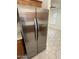 A stainless steel refrigerator complements the cabinets and is a welcome addition to this house at 14543 W Bison Path, Surprise, AZ 85374
