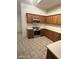 Wood cabinets, countertops, tile flooring, and stainless steel appliances make this kitchen highly functional at 14543 W Bison Path, Surprise, AZ 85374