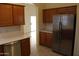 Kitchen view with stainless steel refrigerator and sliding door leading to the backyard at 14543 W Bison Path, Surprise, AZ 85374
