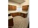The kitchen features wood cabinets, countertops, stainless steel appliances, and tile flooring at 14543 W Bison Path, Surprise, AZ 85374