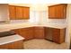 Bright kitchen with light countertops, stainless steel dishwasher, and a window at 14543 W Bison Path, Surprise, AZ 85374