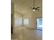 A spacious living room with tile floors, neutral walls, ceiling fans, and sliding doors for easy access at 14543 W Bison Path, Surprise, AZ 85374