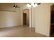 Spacious living room area with tile flooring, arched doorways, and a ceiling fan at 14543 W Bison Path, Surprise, AZ 85374