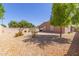 This backyard features desert landscaping, block fence, and a covered patio, perfect for outdoor living at 16468 W Mariposa Grande --, Surprise, AZ 85387