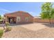 A low maintenance backyard boasts desert landscaping, a block fence, and a covered patio for relaxing at 16468 W Mariposa Grande --, Surprise, AZ 85387