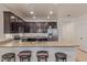 Open kitchen with stainless steel appliances, dark cabinets and a granite countertop at 16468 W Mariposa Grande --, Surprise, AZ 85387