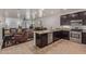Modern kitchen featuring dark wood cabinets, stainless steel appliances and a breakfast bar at 16468 W Mariposa Grande --, Surprise, AZ 85387