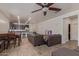 Open-concept living area with tile floors, kitchen, dining area, and ceiling fan at 16468 W Mariposa Grande --, Surprise, AZ 85387