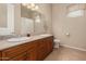 Bathroom featuring double sinks, light wood cabinetry, and a window with plantation shutters at 21774 E Camacho Rd, Queen Creek, AZ 85142