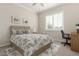 Neutral bedroom featuring a plush bed, a desk area, and a window with plantation shutters at 21774 E Camacho Rd, Queen Creek, AZ 85142