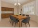 Inviting dining room features a wooden table and a stylish chandelier at 21774 E Camacho Rd, Queen Creek, AZ 85142