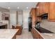 Open kitchen featuring spacious counters, wood cabinets, and modern appliances at 21774 E Camacho Rd, Queen Creek, AZ 85142