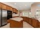 Well-appointed kitchen features ample wood cabinetry, and stainless steel appliances at 21774 E Camacho Rd, Queen Creek, AZ 85142