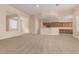 Spacious open-concept living room with neutral paint, leading to the kitchen at 21774 E Camacho Rd, Queen Creek, AZ 85142