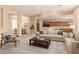 Bright living room with neutral decor, and open layout to kitchen and dining area at 21774 E Camacho Rd, Queen Creek, AZ 85142