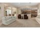 Spacious living room with neutral tones, plush seating, and an open layout to the kitchen and dining areas at 21774 E Camacho Rd, Queen Creek, AZ 85142