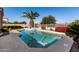 Swimming pool surrounded by lush landscaping, a mature palm tree, and a sunny sky at 21774 E Camacho Rd, Queen Creek, AZ 85142