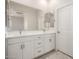 Bathroom featuring double sinks, white vanity, and large mirror at 5649 N 205Th Ln, Buckeye, AZ 85396