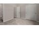 A simple bedroom featuring neutral paint and carpet, with an attached bathroom and closet at 5649 N 205Th Ln, Buckeye, AZ 85396