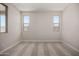Neutral bedroom featuring carpeted flooring and two windows at 5649 N 205Th Ln, Buckeye, AZ 85396