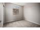 This bedroom has neutral paint, carpet, and a window for natural light at 5649 N 205Th Ln, Buckeye, AZ 85396