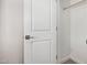 Open closet with hanging rod behind a white door and handle at 5649 N 205Th Ln, Buckeye, AZ 85396