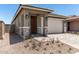 Charming single-Gathering home featuring a front door, two-car garage, and a well-maintained, professionally-designed paver driveway at 5649 N 205Th Ln, Buckeye, AZ 85396
