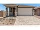 Charming single-Gathering home featuring a front door, two-car garage, and a well-maintained, professionally-designed paver driveway at 5649 N 205Th Ln, Buckeye, AZ 85396