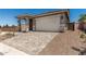 Charming single-Gathering home featuring a front door, two-car garage, and a well-maintained, professionally-designed paver driveway at 5649 N 205Th Ln, Buckeye, AZ 85396
