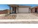Charming single-Gathering home featuring a front door, two-car garage, and a well-maintained, professionally-designed paver driveway at 5649 N 205Th Ln, Buckeye, AZ 85396