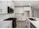 Modern kitchen with stainless appliances, gas cooktop, white quartz counters, and tiled backsplash at 5649 N 205Th Ln, Buckeye, AZ 85396